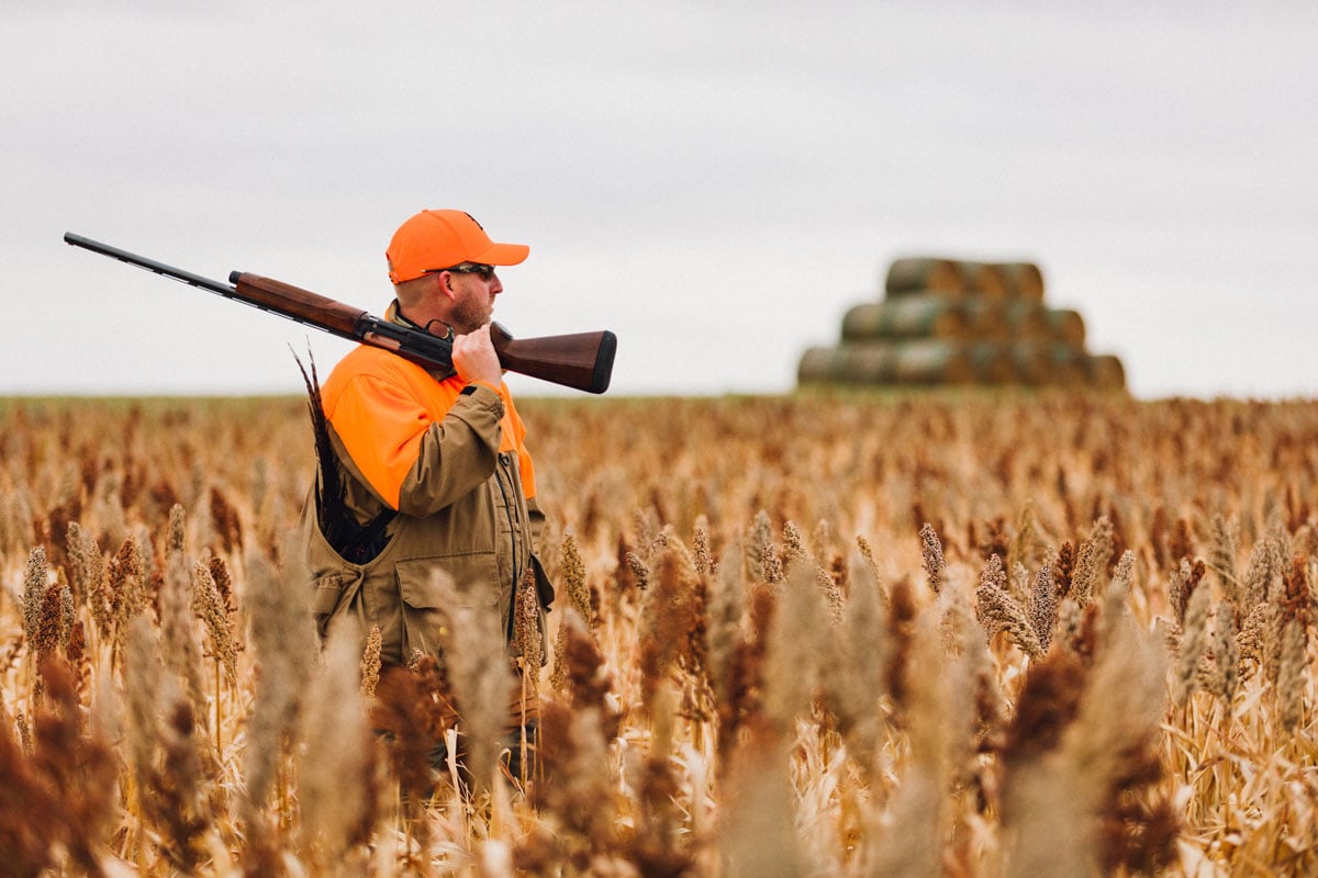 Man with semi-automatic rifle in a field