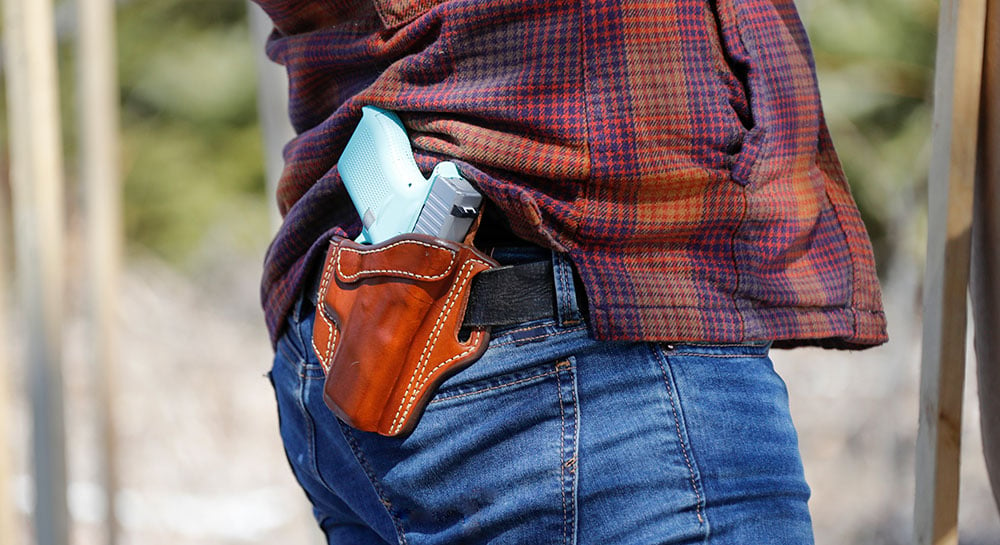 man carrying handgun in holster